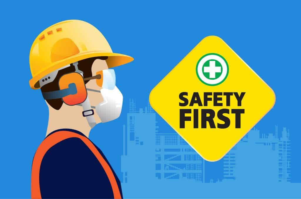 Safety First — construction worker wearing helmet, ear defenders and mask
